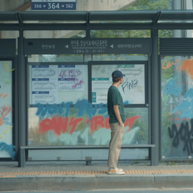 NamJoon at the bus stop observes TaeHyung's graffiti