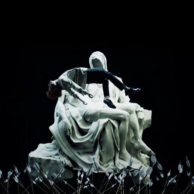 j-hope in front of the Pietà in The WINGS Tour Concert Trailer
